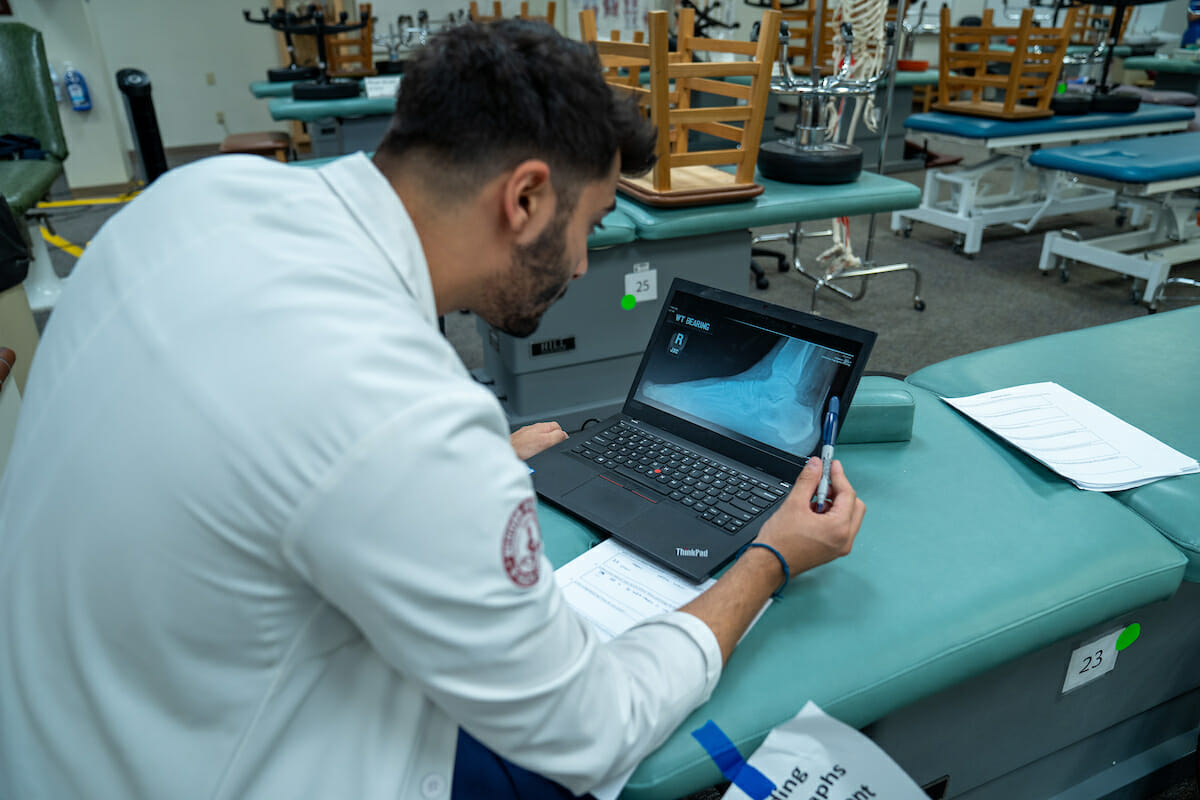 Third-year College of Podiatric Medicine student Mena Messiha goes through a PowerPoint on reading radiographs during a Clinical Skills Workshop.