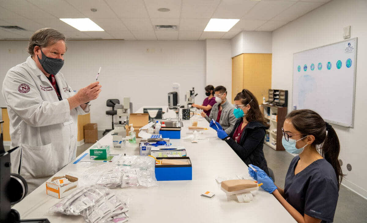 Image of College of Graduate Nursing students learning how to give immunizations