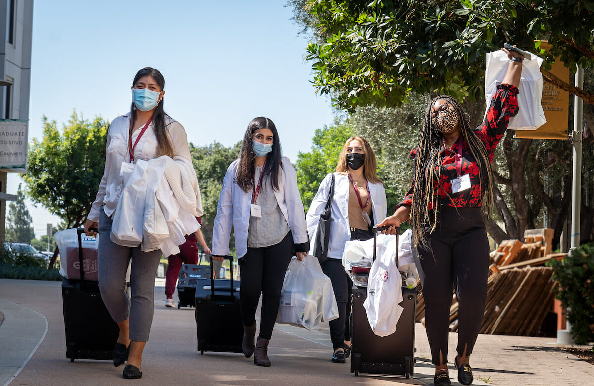 College of Optometry incoming students Cindy Diaz, left, Sukaina Zaidi, Natalie Aghazarian and Jazmine Smith walk the Esplanade during WesternU Welcome Week day three,