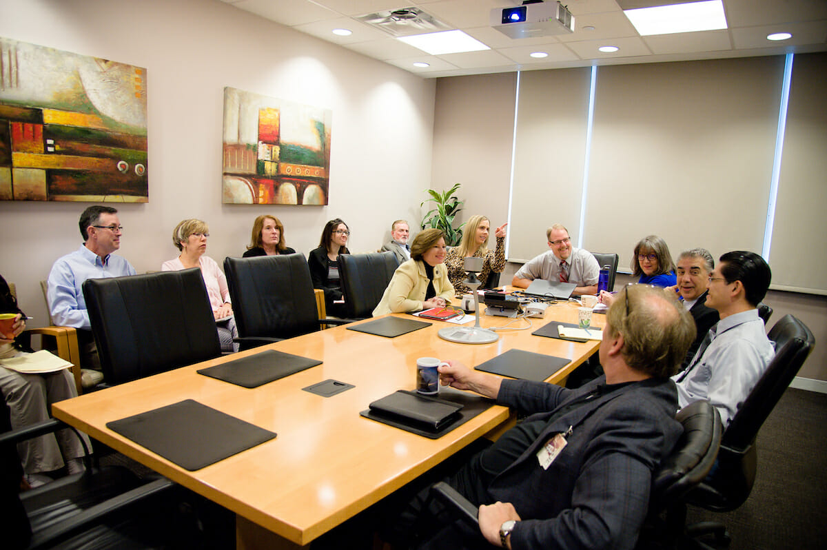 COMP and COMP-Northwest Dean Paula Crone, DO, meets with faculty and staff on the Pomona campus that was video-linked to the Lebanon campus. The meeting is called a huddle.