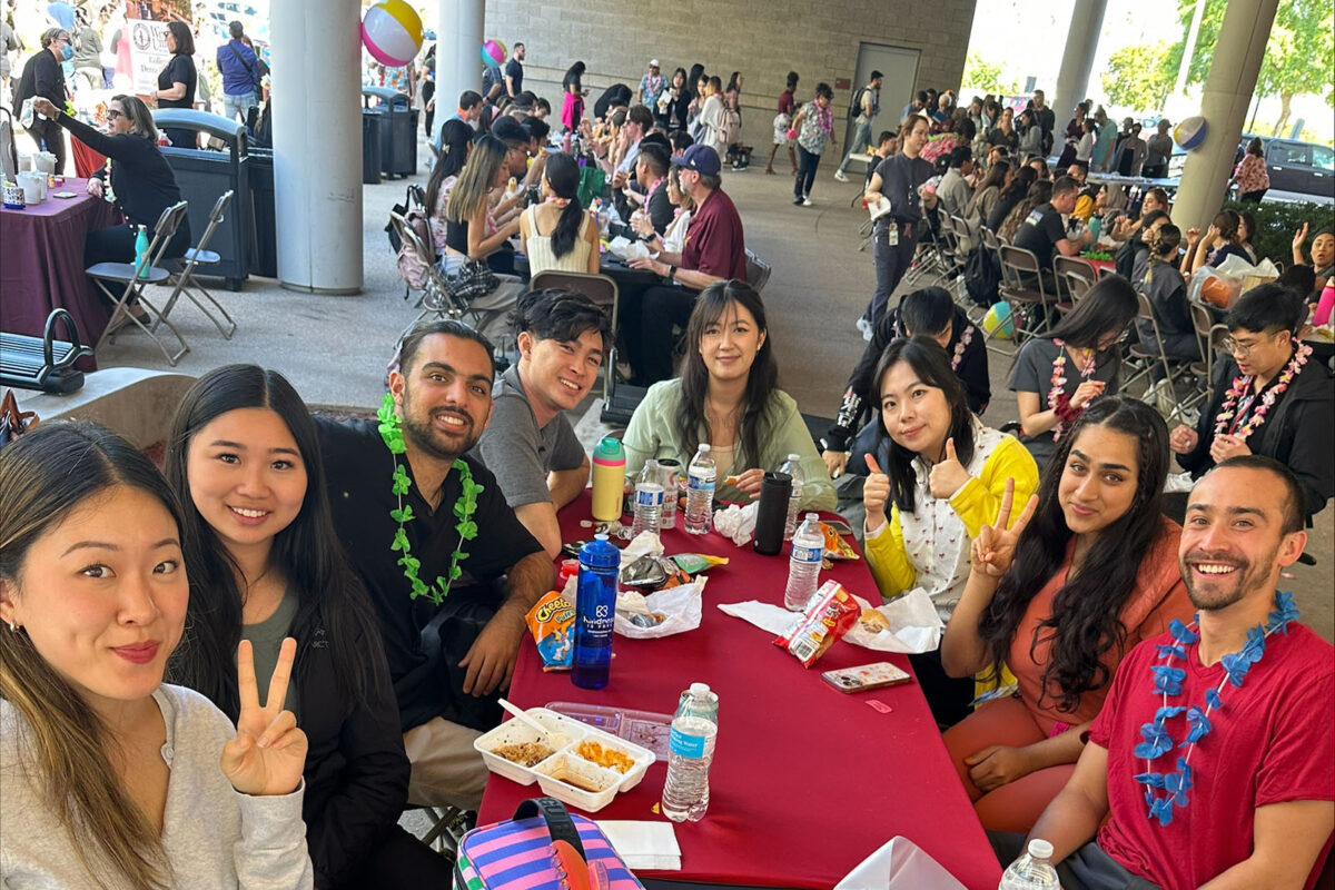 A group of people posing for a photo at Family Field Day, California campus, Oct. 2023.