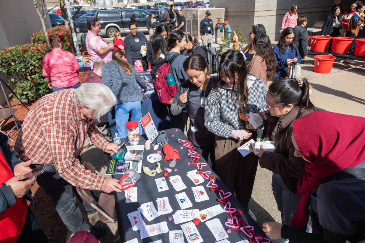 A group of people at a table with cards.