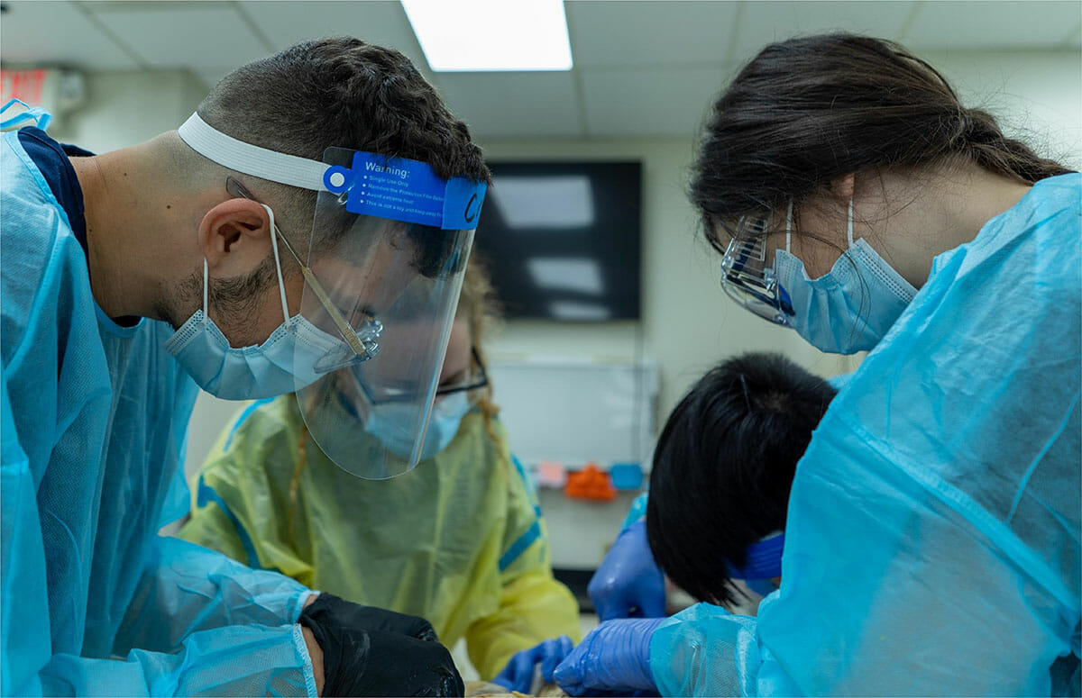 Photo of students around a patient