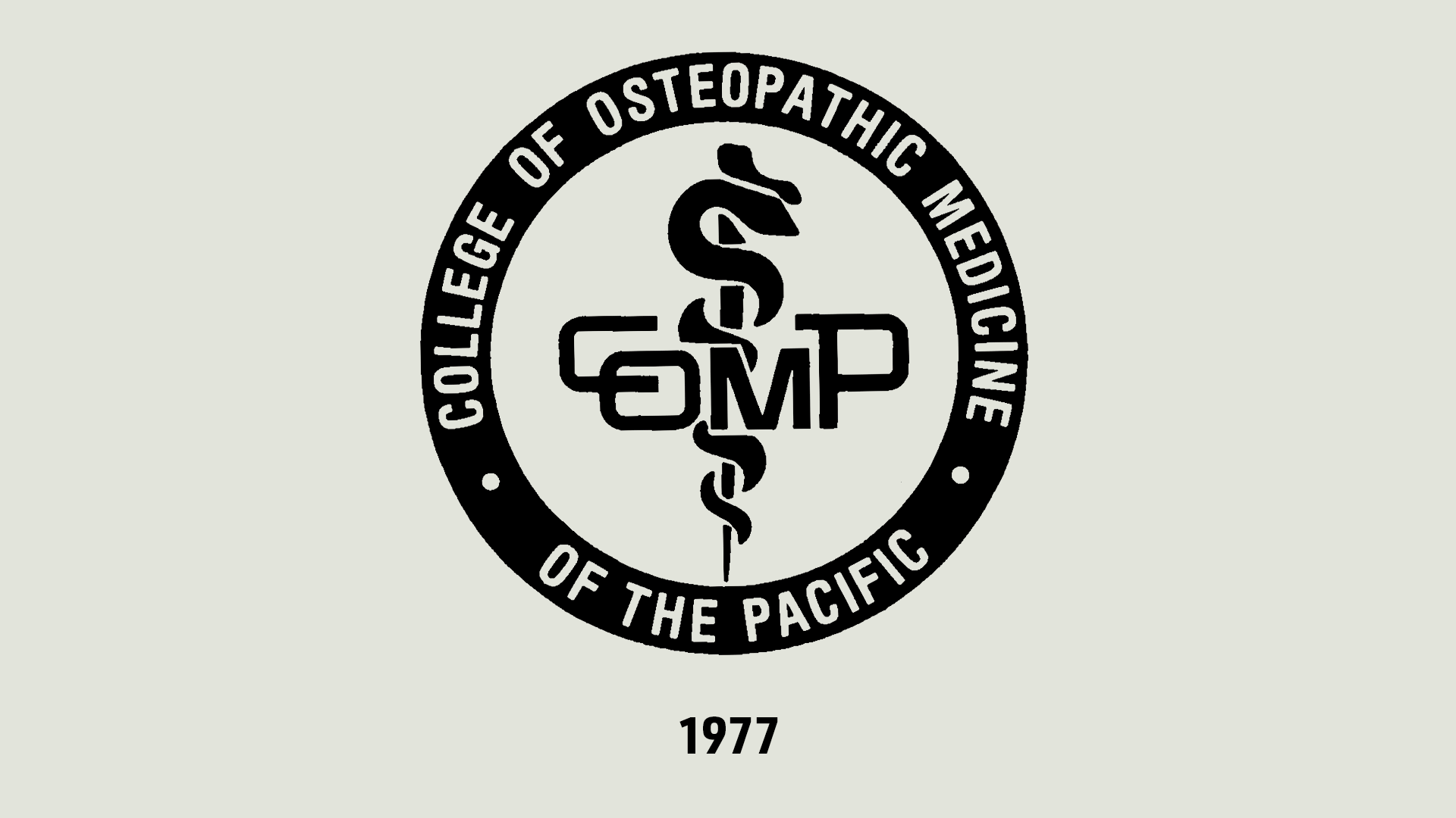 Circular College of Osteopathic Medicine of the Pacific logo with a rod of Asclepius and “COMP” in the center; “1977” is written below.