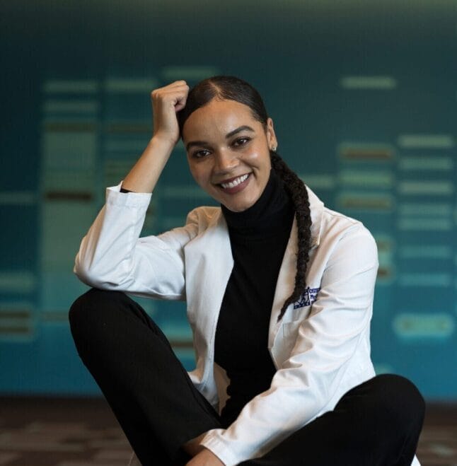 Woman sitting with legs crossed and smiling