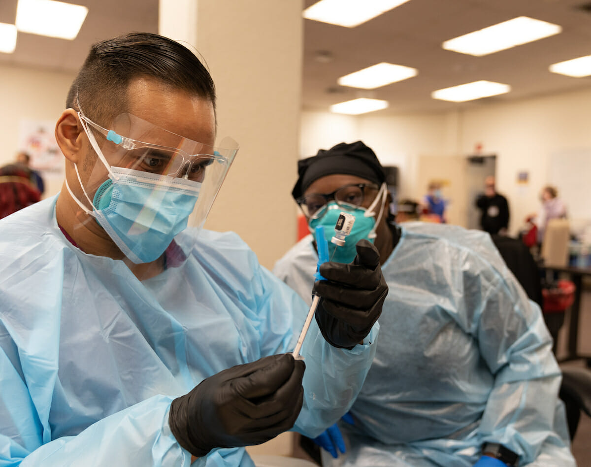 Student volunteering at a large-scale health screening.