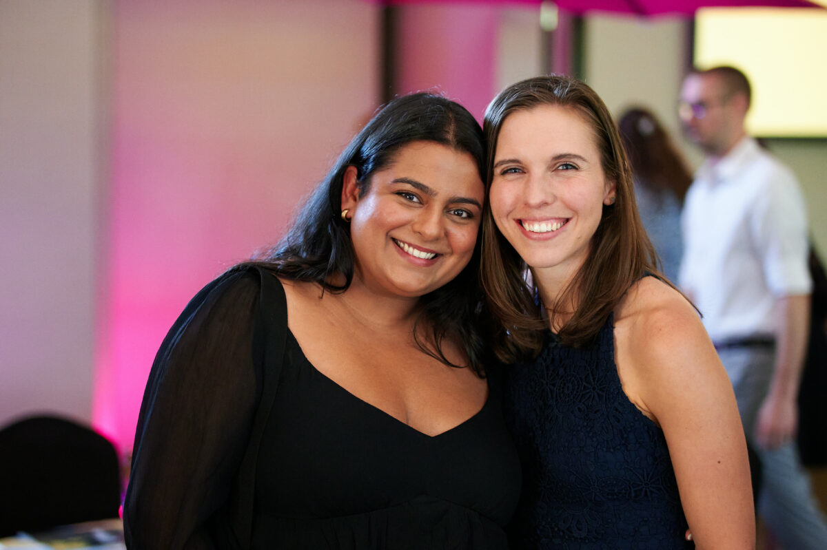 Two women posing for a photo at an event.