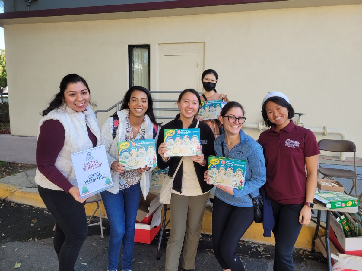 A group of women holding craft kits waiting for the children to arrive.