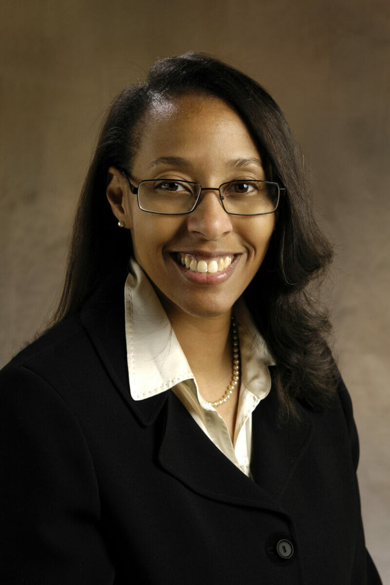 woman, glasses, black jacket.