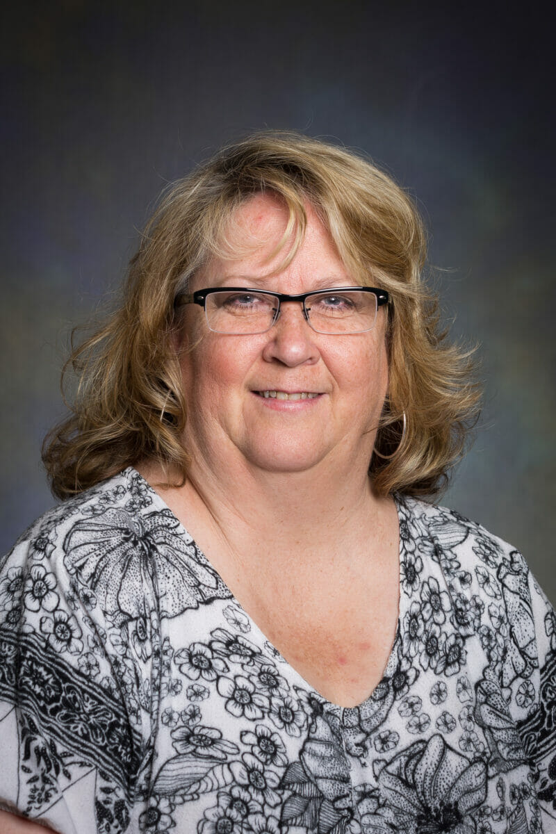 woman, glasses, smiling.