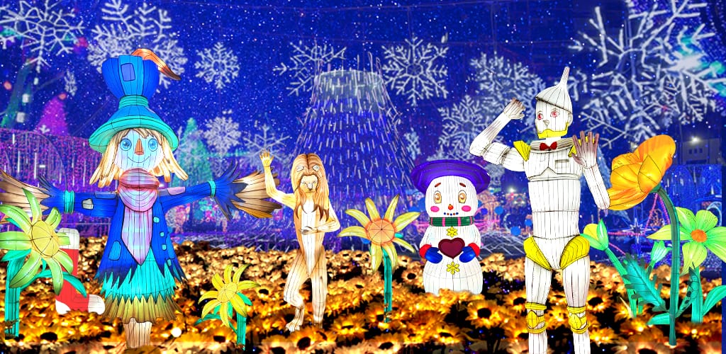 Four colorful, cartoon-like characters stand in a field of bright yellow flowers with illuminated snowflakes and festive lights in the background.