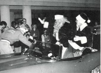 Santa claus and Mrs. claus in a car at the first Santa's Workshop in 1994