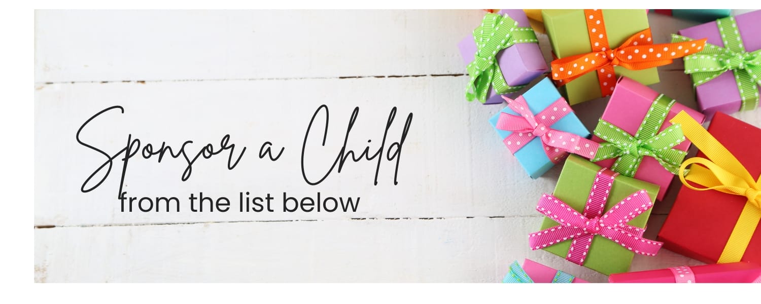 Colorful gift boxes with ribbons are scattered on a white wooden surface. Text reads: "Sponsor a Child from the list below.
