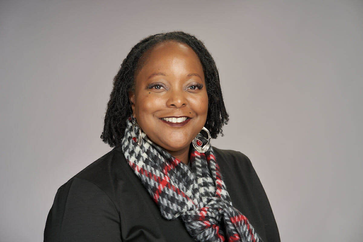 black woman, plaid scarf