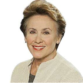 A woman in a white jacket is smiling for the camera.
