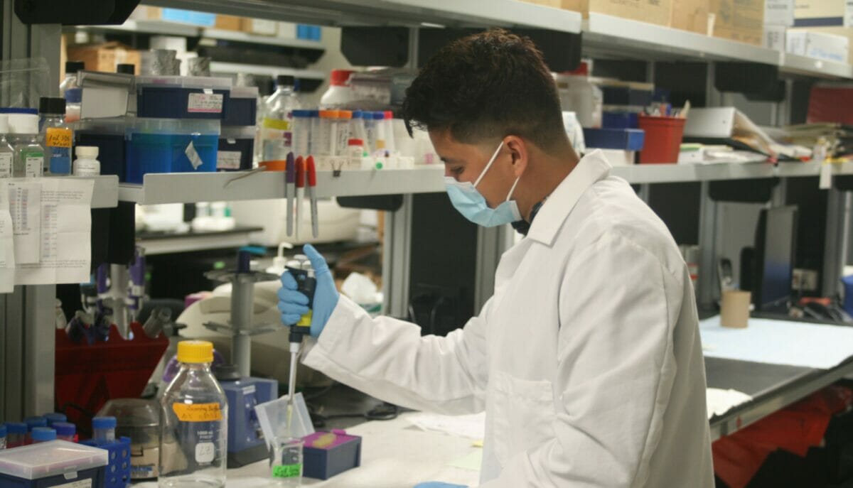 Student working with pipette in lab