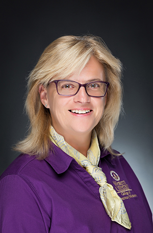 Dr. Suzana Tkalcic portrait with a WesternU purple shirt on black background.