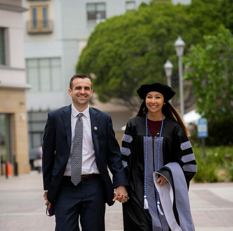 Students holding hands graduation