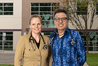 woman and man standing next to each other smiling
