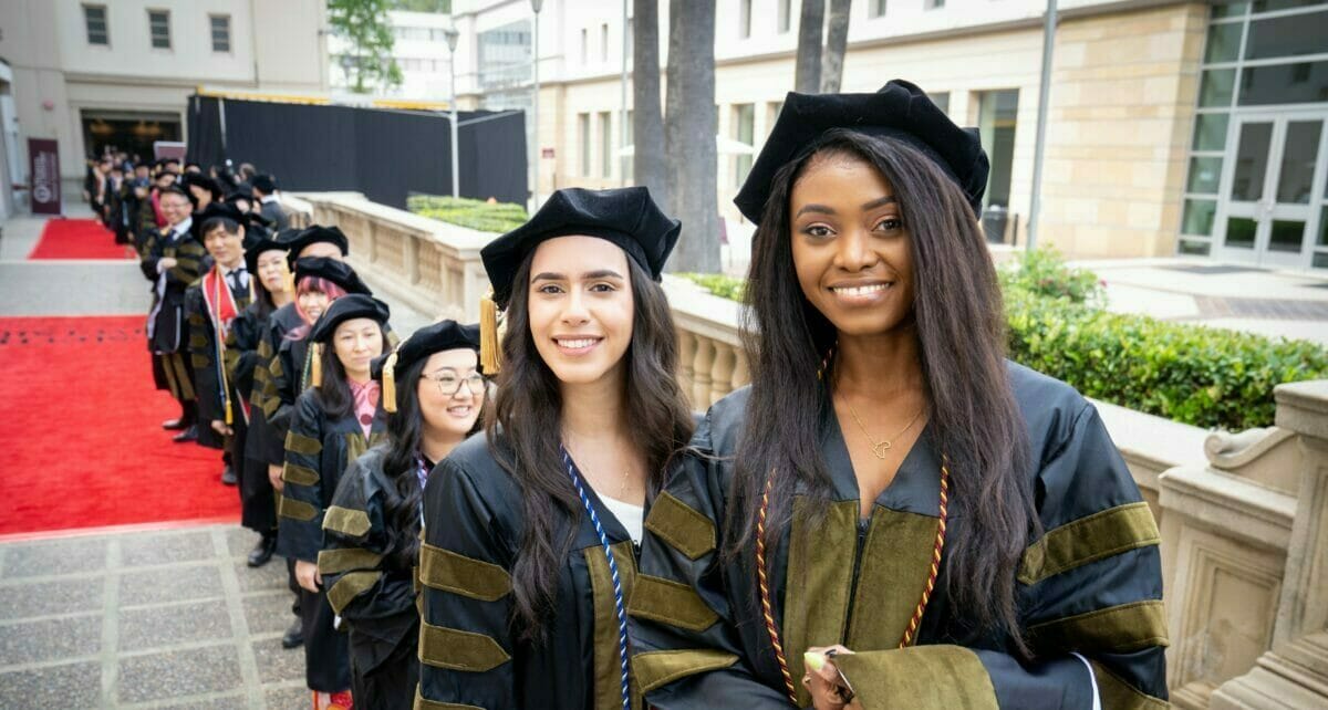 Graduates in a line outside at commencement in Pasadena