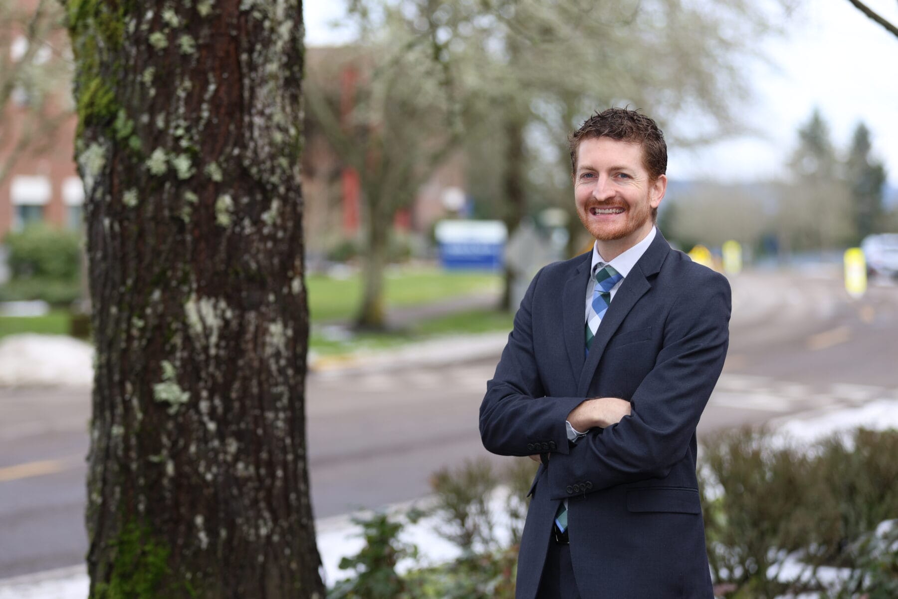 Man standing next to tree.