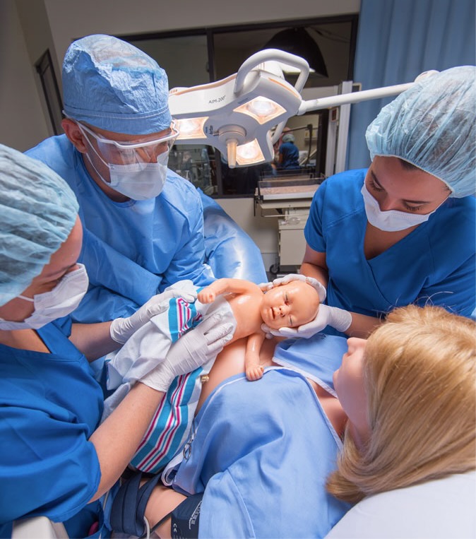 patient simulator with baby and doctors